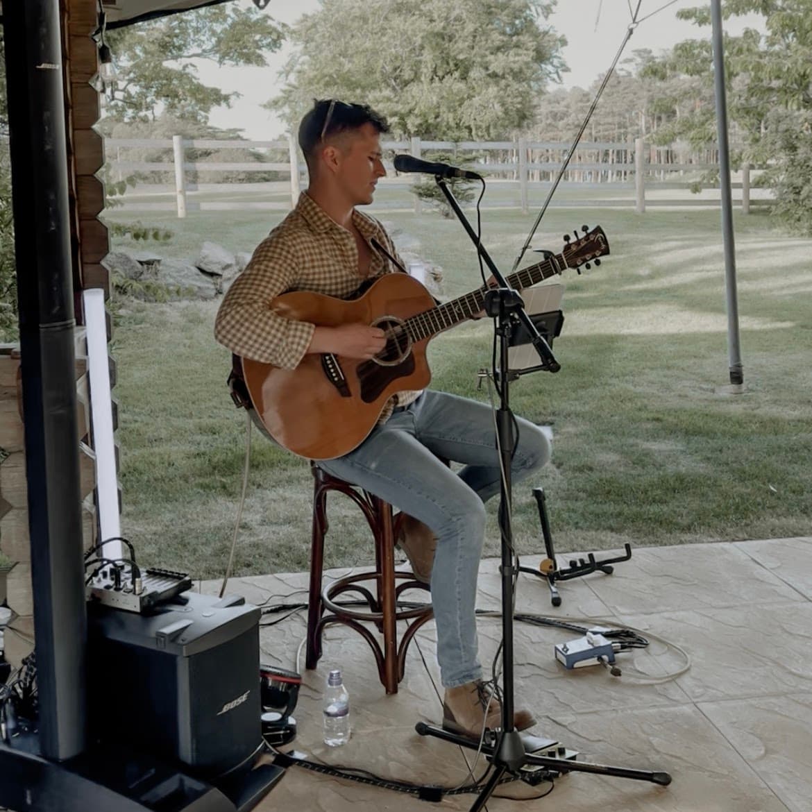 Robbie Wisniewski performing outdoors on a patio at a night-before wedding celebration