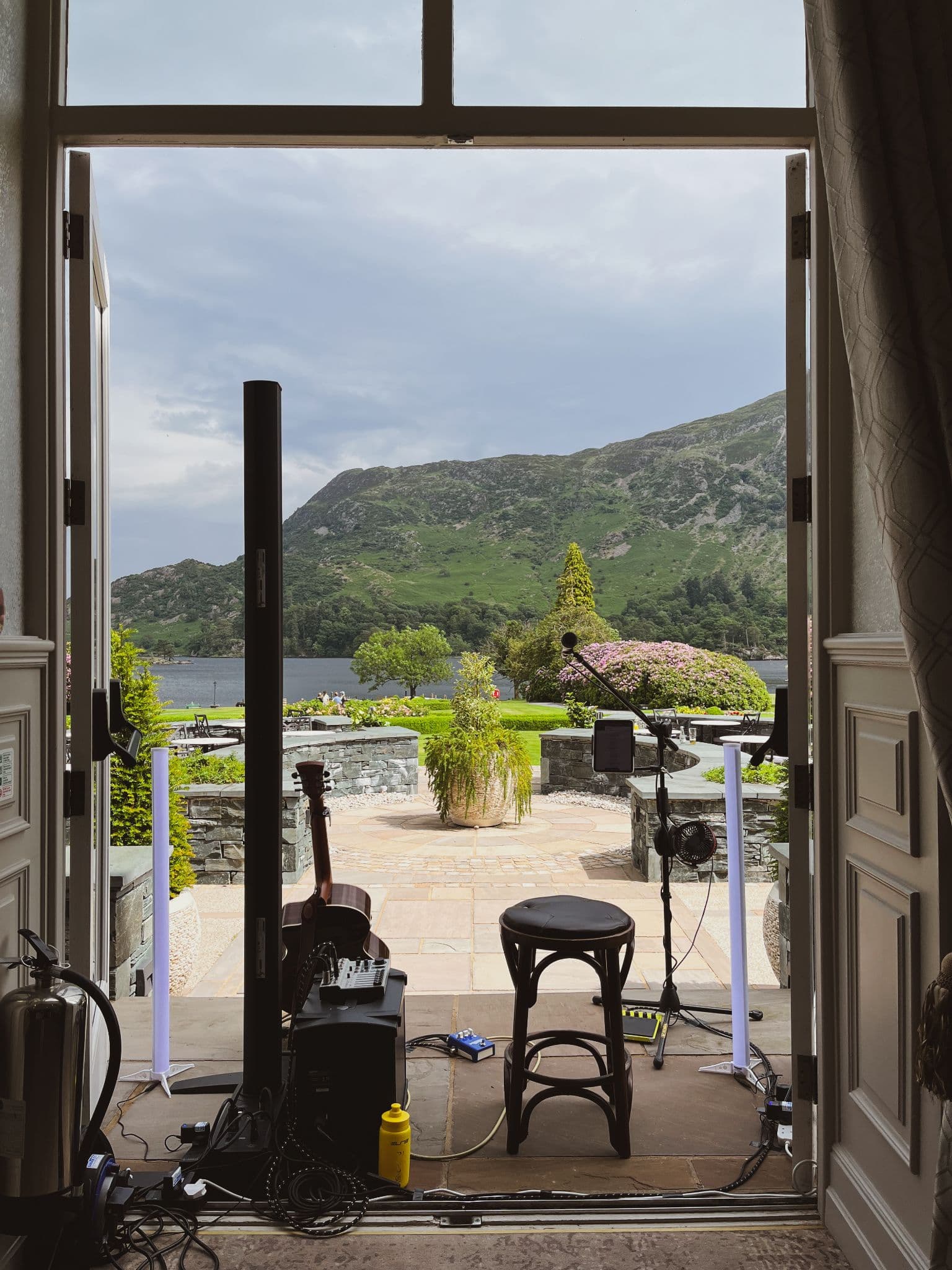 Live music setup in an open doorway looking out over a Scottish loch